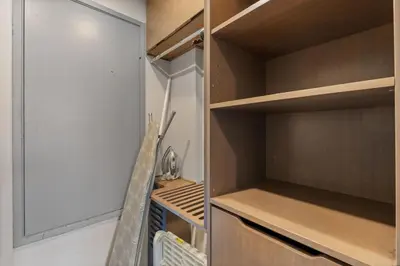a walk in closet with wooden shelves at Stylish Westwood Condo, Near UCLA & Century City in Los Angeles