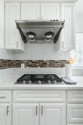 a stove top in a kitchen with white cabinets at Ideal 4BR2BA Home for Family Vacations in Alhambra