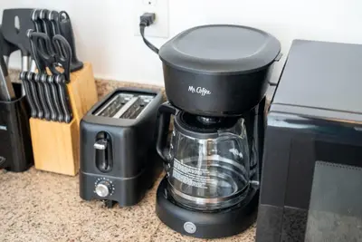 a black blender sitting on a counter next to a microwave at Cozy 2BR2BA Guest House in Alhambra in Alhambra