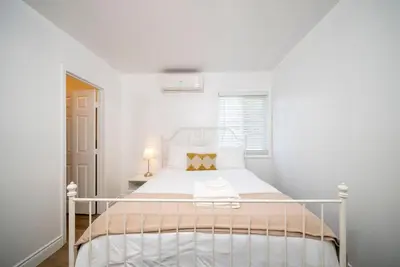 a bedroom with a white bed with a white bedspread at Cozy 2BR2BA Guest House in Alhambra in Alhambra