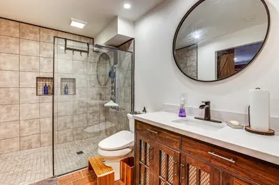 a bathroom with a shower and a toilet and a sink at 3 Mi to Lake Arrowhead Village Dog-Friendly Cabin in Lake Arrowhead