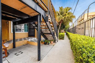 a building with a staircase next to a sidewalk at Amazing Berryman 1bd#8 in Los Angeles