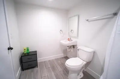 a white bathroom with a toilet and a sink at Stylish Private Ensuite Room near USC in Los Angeles
