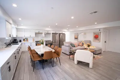 a kitchen and living room with a table and chairs at Stylish Private Ensuite Room near USC in Los Angeles
