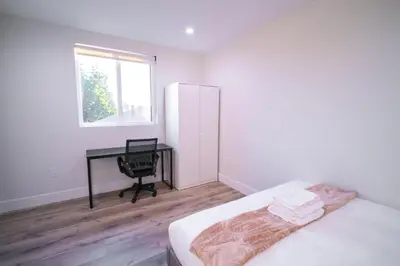 a bedroom with a bed and a desk and a chair at Modern Private Ensuite Room near USC in Los Angeles