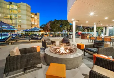 a patio with a fire pit with chairs and tables at Marina Escape 2BR Townhouse with FREE PARKING in Los Angeles