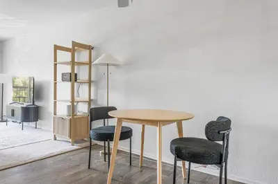 a table and chairs in a room with a wall at Blueground Hollywood Hills jacuzzi nr Runyon Canyon LAX-1380 in Los Angeles
