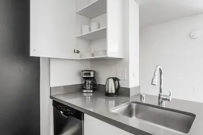 a kitchen with white cabinets and a sink at Blueground Hollywood Hills jacuzzi nr Runyon Canyon LAX-1380 in Los Angeles