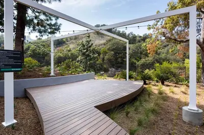 a wooden boardwalk in a garden with a pergola at Blueground Hollywood Hills jacuzzi nr Runyon Canyon LAX-1380 in Los Angeles