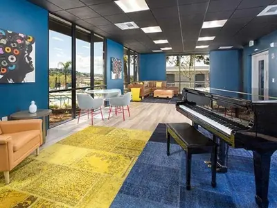 a living room with a piano in a room with furniture at Blueground Hollywood Hills jacuzzi nr Runyon Canyon LAX-1380 in Los Angeles