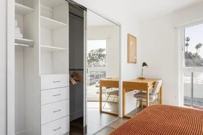 a bedroom with a desk and a mirror at Blueground Sawtelle rooftop nr Culver City Park LAX-1373 in Los Angeles