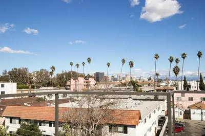 a view of a city with palm trees and buildings at Blueground Sawtelle rooftop nr Culver City Park LAX-1373 in Los Angeles