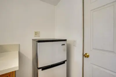 a refrigerator in a kitchen next to a door at 3 Mi to Beaches Low-Key San Pedro Rental! in San Pedro