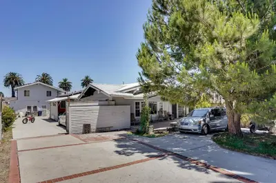 a house with a car parked in a driveway at 3 Mi to Beaches Low-Key San Pedro Rental! in San Pedro
