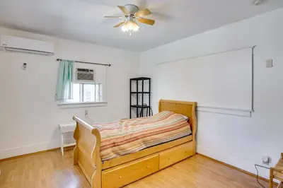 a bedroom with a bed and a ceiling fan at 3 Mi to Beaches Low-Key San Pedro Rental! in San Pedro