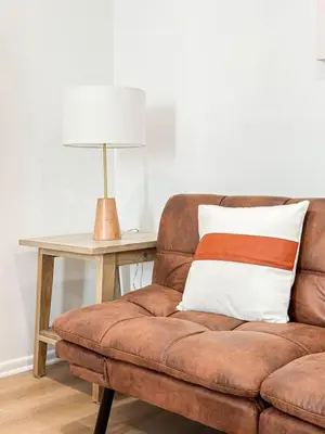 a brown couch sitting next to a table with a lamp at Cozy Boho 2BR Near Beverly Hills - DOH2 - CUL in Los Angeles
