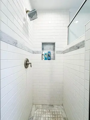 a white tiled shower with two blue toothbrushes at Cozy Boho 2BR Near Beverly Hills - DOH2 - CUL in Los Angeles