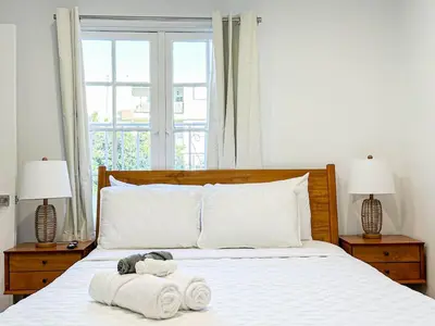 a bed with towels and a stuffed animal on it at Cozy Boho 2BR Near Beverly Hills - DOH2 - CUL in Los Angeles