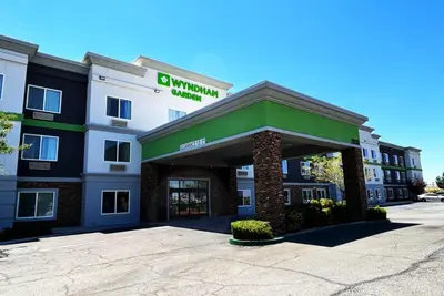 a front view of a hotel with a building at Wyndham Garden Lancaster CA in Lancaster