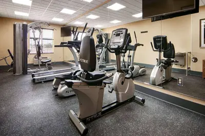 a gym with several treadmills and cardio machines at Wyndham Garden Lancaster CA in Lancaster