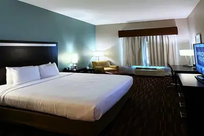 a hotel room with a large bed and a television at Wyndham Garden Lancaster CA in Lancaster