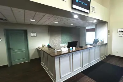 an office with a reception counter with two computers on it at Wyndham Garden Lancaster CA in Lancaster