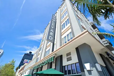 a building with a sign on the side of it at Miracle Mile Apartments in Los Angeles
