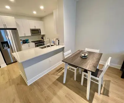 a kitchen with a wooden table and a table and chairs at Miracle Mile Apartments in Los Angeles