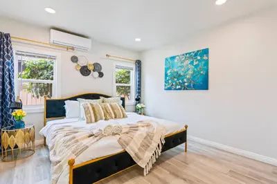 a bedroom with a bed and a painting on the wall at Prime location King Bed! Private house1 in Alhambra