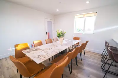 a dining room with a long table and chairs at The Command Suite Urban Comfort Near USC in Los Angeles