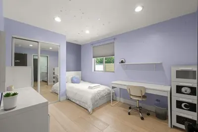 a purple bedroom with a bed and a desk at The Royer Retreat With Pool and Hot tub in Los Angeles
