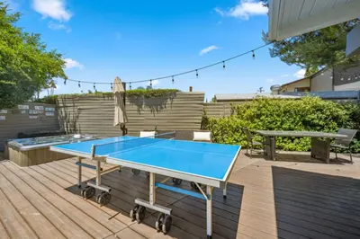 a blue ping pong table on a wooden deck at The Royer Retreat With Pool and Hot tub in Los Angeles