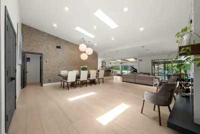 a dining room and living room with a table and chairs at The Royer Retreat With Pool and Hot tub in Los Angeles