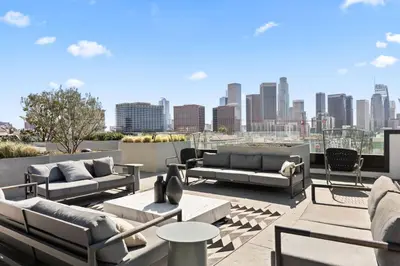 a rooftop patio with couches and a city skyline at Skyline Haven Near Dodger Stadium with Views in Los Angeles
