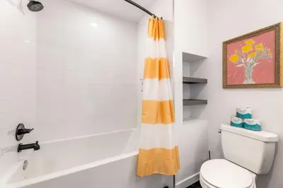 a bathroom with a shower curtain next to a toilet at Skyline Haven Near Dodger Stadium with Views in Los Angeles