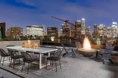 a table and chairs on a rooftop with a fire pit at Skyline Haven Near Dodger Stadium with Views in Los Angeles