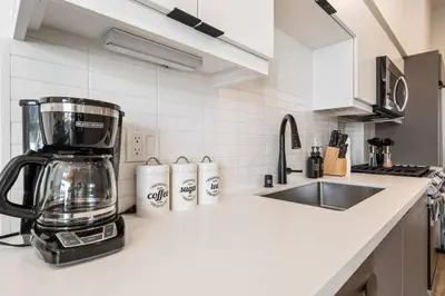 a kitchen with a coffee maker on a counter at Chic Studio, Walk to Downtown With Skyline Views in Los Angeles