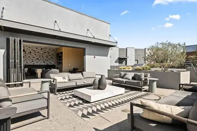 a patio with couches and chairs and a fireplace at Chic Studio, Walk to Downtown With Skyline Views in Los Angeles