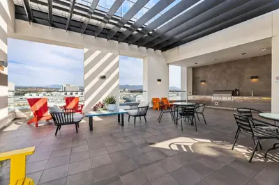 a patio with tables and chairs on a building at 2BD 2BA Stylish Arts District Retreat, Walk to Little Tokyo in Los Angeles