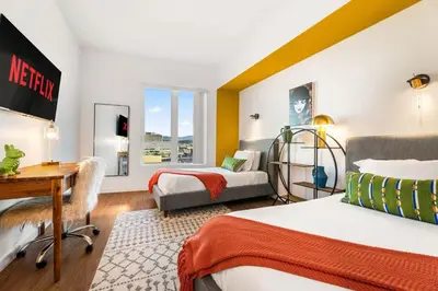 a hotel room with two beds and a desk and a desk at 2BD 2BA Stylish Arts District Retreat, Walk to Little Tokyo in Los Angeles