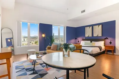 a living room with a bed and a table at Modern Studio Retreat in the Heart of Art District in Los Angeles