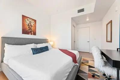 a bedroom with a large bed and a desk at Arts District Condo, Walk to Little Tokyo Plaza in Los Angeles