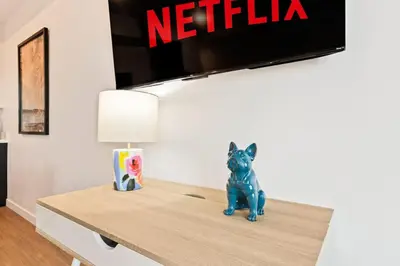 a toy dog sitting on a table under a television at Chic Studio with Stunning DTLA Views, Walk to Metro in Los Angeles
