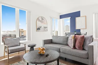 a living room with a couch and a table at Spacious 1-BD with Stunning City Views in DTLA in Los Angeles