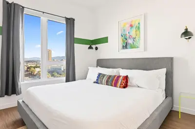 a bedroom with a large bed with a large window at Spacious 1-Bedroom Gem with Downtown LA Views in Los Angeles