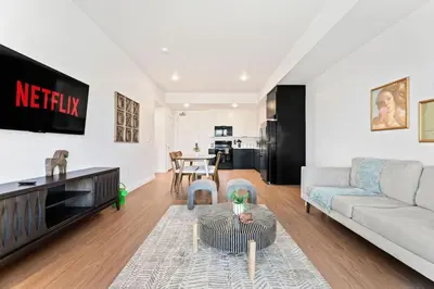 a living room with a couch and a tv at Spacious 1-Bedroom Gem with Downtown LA Views in Los Angeles