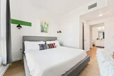 a bedroom with a large white bed in a room at Spacious 1-Bedroom Gem with Downtown LA Views in Los Angeles