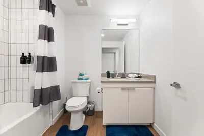 a bathroom with a toilet and a sink and a shower at Spacious 1-Bedroom Gem with Downtown LA Views in Los Angeles