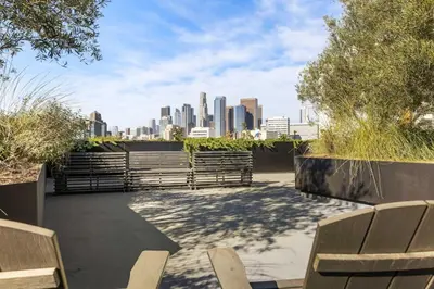 a patio with benches and a city skyline at Designer Stay in Arts District, Walk to Little Tokyo in Los Angeles