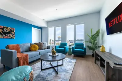 a living room with blue walls and a couch and chairs at Chic and Cozy Home, Walk to Little Tokyo with Parking in Los Angeles